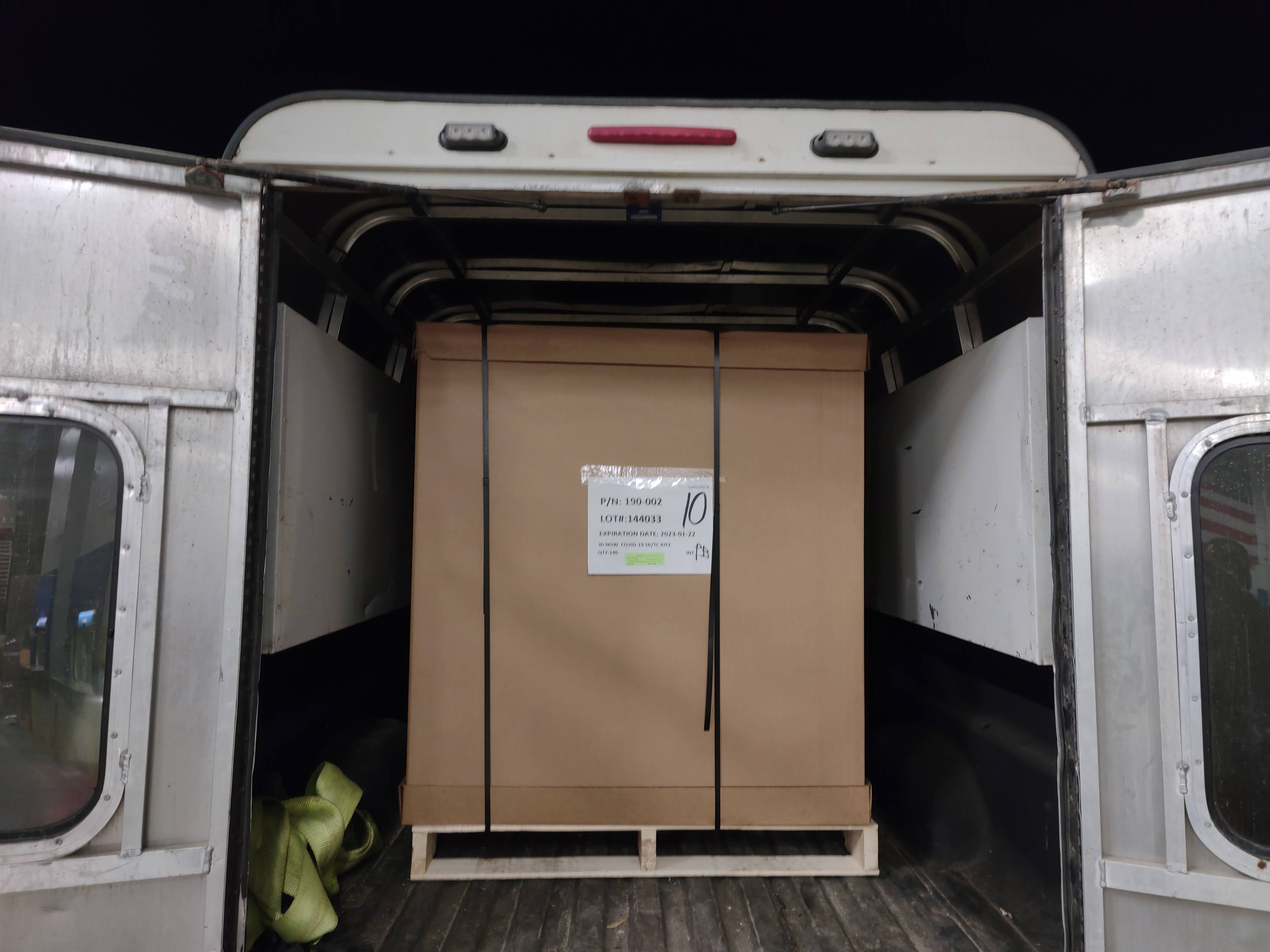 Securely strapped cargo box inside a Comet Couriers delivery van